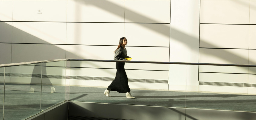 Frau geht über Büroflur